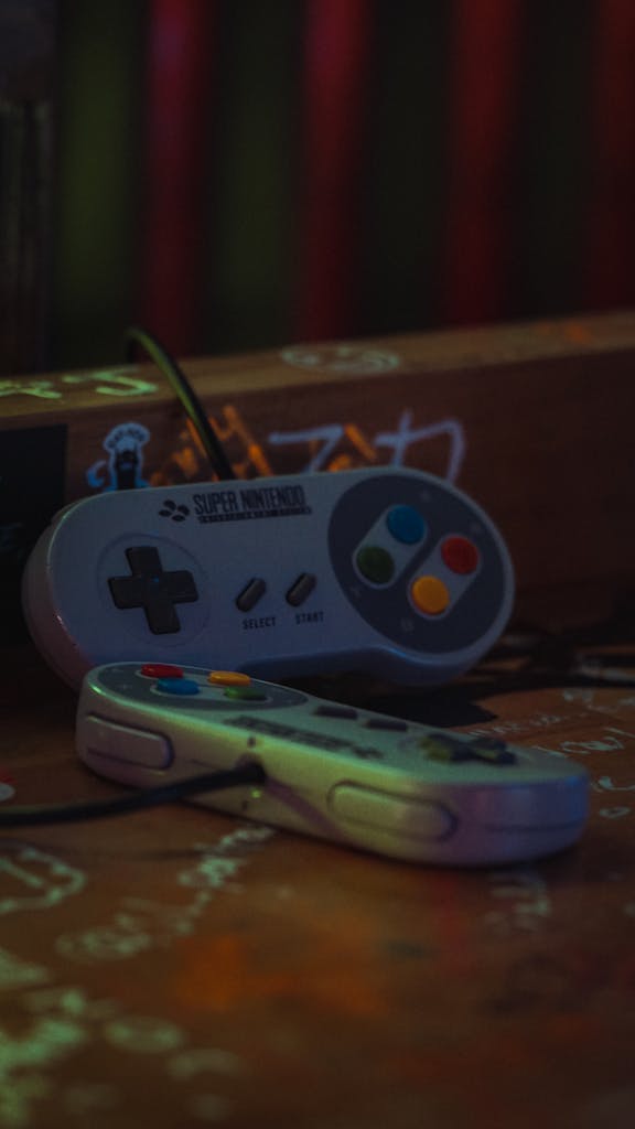 Close-up of vintage Super Nintendo game controllers on a dark surface.