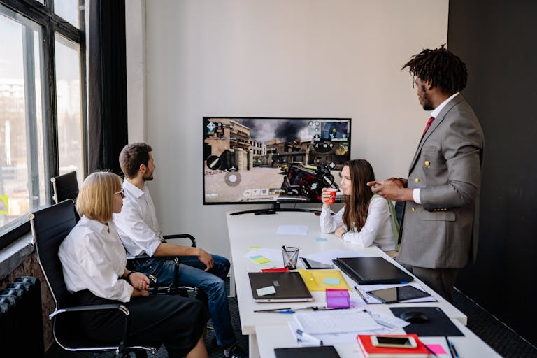 Diverse group of colleagues engaging in video game session during office hours.